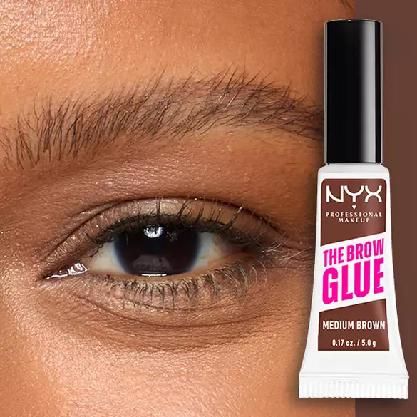 Close-up of an eye and brow with NYX Professional Makeup The Brow Glue Instant Brow Styler in Medium Brown shown beside the brow for a defined, brushed-up finish.