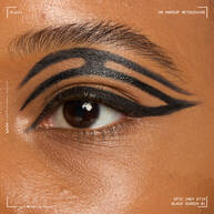 Close of a model wearing Epic Inky Stix on the top of their eyelid as a winged liner style in shade 01 Black Screen